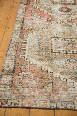 Distressed vintage Oushak runner border, geometric latch motif, dusty blush, charcoal, low pile.