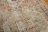 Distressed Oushak rug pile texture with even wear, showing blush, red, charcoal motifs.
