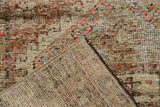 Distressed Oushak rug pile showing even wear, dusty blush, red, and charcoal tones with hand-knotted reverse.