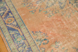 Vintage Oushak rug's distressed pile texture, revealing pale rose, blue, and subtle green hues.