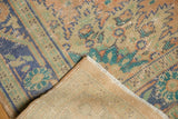 Distressed vintage Oushak carpet pile with faded blue, peach, green colors and woven foundation.