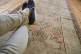 Decorative distressed Oushak runner, showing faded rose motifs and soft texture.