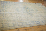 Distressed Oushak rug in faded ivory and dusty blue with Rococo floral patterns. 6'9