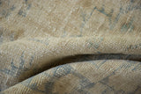 Soft, distressed texture of vintage Oushak pile, revealing faded blue and antique ivory patterns.