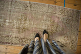 Textured pile of the distressed Oushak runner, revealing even wear and soft lilac and bronze tones.