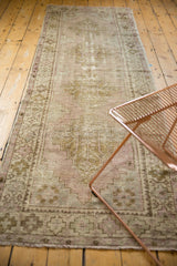 Vintage Distressed Oushak rug, showing faded lilac and bronze patterns with visible foundation.