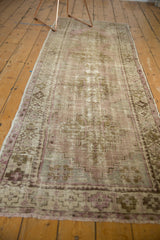 Distressed Oushak runner, pale lilac and ivory geometric pattern with exposed foundation.