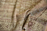 Distressed Oushak runner's worn pile and visible foundation with pale lilac motifs.
