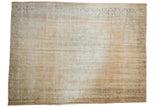 Distressed vintage Oushak rug in faded ivory and apricot with subtle floral and palmette border.