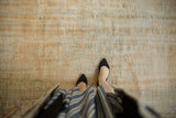 Distressed vintage Oushak rug showing even wear to pile, with muted ivory and sand tones.