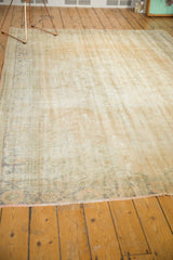 Distressed Oushak carpet with soft ivory, sand, and pale blue tones; mostly even wear.