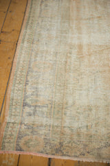 A decorative distressed Oushak rug showing its muted colors and worn pile texture.