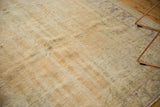 Distressed vintage Oushak rug texture showing mostly even wear and muted ivory tones.