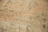Worn pile and exposed foundation of a distressed Oushak carpet with pale peach vinery.
