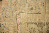 Distressed Oushak rug: worn pile texture, visible foundation, pale peach fringe, woven reverse.