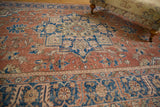 Vintage distressed Oushak carpet showing worn pile texture, faint foundation, dusty red, blue vinery.