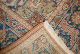 Corner fold of hand-knotted vintage Oushak rug, showing distressed pile and woven foundation.