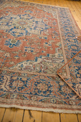 Fringe and distressed rust, blue, ivory border of the vintage Oushak rug.