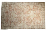 Distressed hand-knotted Turkish Oushak rug with faded blush rose and ivory medallion, 6'2
