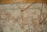 Distressed Oushak carpet with soft blush rose and antique ivory, revealing faint foundation.