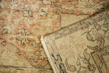 Distressed vintage Oushak rug, showing pale blush pile wear and hand-knotted foundation.