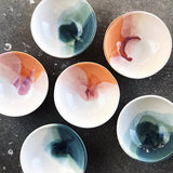 A collection of handmade ceramic ring dishes with desert and green watercolor glazes.