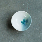 Overhead view of the Ocean ceramic ring dish's deep teal and seafoam watercolor interior.