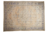 Distressed vintage Oushak carpet, faded ivory field, dusty blue floral medallion design.
