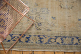 Distressed vintage Oushak carpet border, worn texture revealing foundation, with dusty royal blue design.