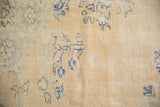 Close-up of distressed Oushak carpet: mostly even wear, foundation showing through, pale sand, dusty blue, seafoam green abrash.