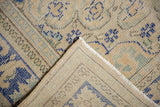 Distressed vintage Oushak pile with side selvage and hand-knotted foundation.