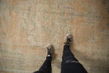 Distressed Oushak texture, worn pile, visible foundation, pale apricot, and faded blue.