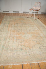 Distressed Oushak carpet pile with even wear, pale apricot, and ivory tones.