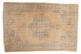 Vintage Distressed Oushak carpet with Rococo medallion, pale sand, beige, and dusty blue tones.