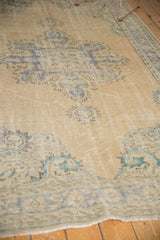 Distressed Oushak carpet pile with lazy lines, faded sand, blue, and mint green motifs.