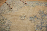 Distressed vintage Oushak rug pile revealing lazy lines, with dusty blue and sand Rococo motifs.