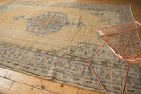 Time-softened tones and scalloped medallion detail on vintage distressed Oushak carpet.