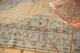 Distressed Oushak carpet border, beige, dusty blue, and mint green curvilinear patterns.
