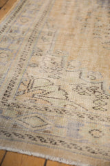 Decorative distressed Oushak carpet texture with worn beige, pale blue, and green pile.