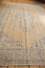 Corner detail of distressed Oushak rug, showing even wear, faint foundation, and delicate fringe.