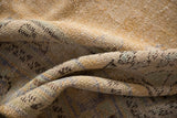 Distressed Oushak rug pile texture showing even wear, beige, and faint blue-green hues.