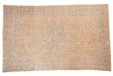 Vintage Distressed Oushak carpet with faded scalloped medallion, beige field, and muted blue boteh paisley, 6' x 9'11