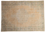 Distressed Vintage Oushak carpet, faded beige field with subtle medallion and blue-green borders.