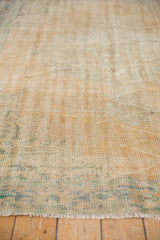 Distressed Oushak carpet pile featuring faded beige and subtle blue green hues.