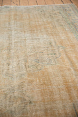 Distressed vintage Oushak carpet texture with mostly even wear and exposed foundation.