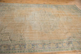 Mostly even worn texture of a vintage Oushak rug in soft beige, gold, and blue.
