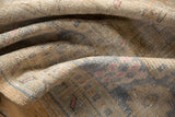 Distressed Oushak rug pile with decorative wear, showing beige, faded blue, and blush pink tones.