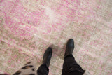 Distressed Sivas carpet textural detail with fuchsia pink and beige tones.