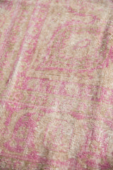 Distressed Sivas carpet texture, fuchsia and beige floral motifs with visible foundation.