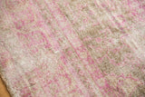 Textured low pile of a distressed Sivas rug in fuchsia pink and neutral sand tones.